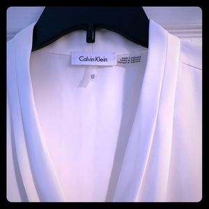 Sleeveless, timeless white Calvin Klein blouse.